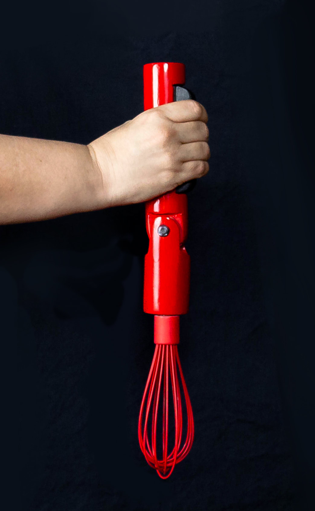 Holding the ergo whisk model in the extended verticle position.